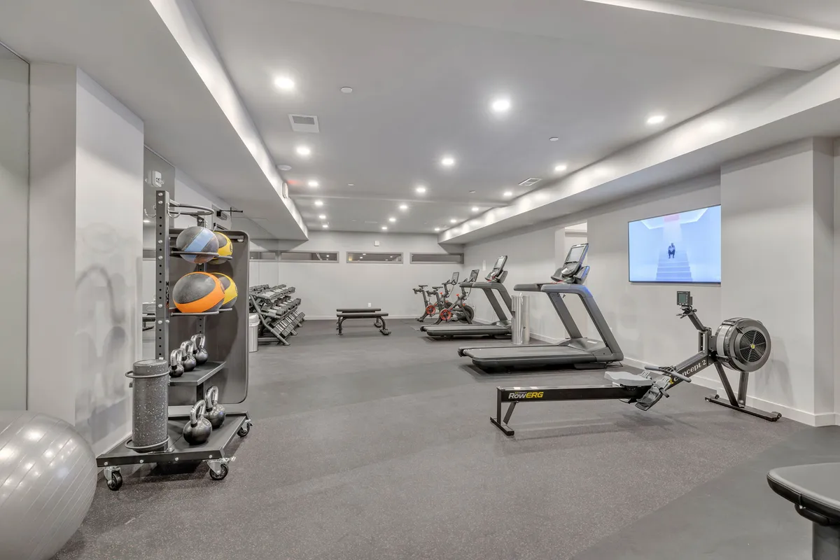 Inside the state-of-the-art gym, you’ll find rows of treadmills, stationary bikes, rowing machines, a weight rack, and exercise balls. The space is bright, modern, and energetic—designed for serious workouts or group fitness classes.