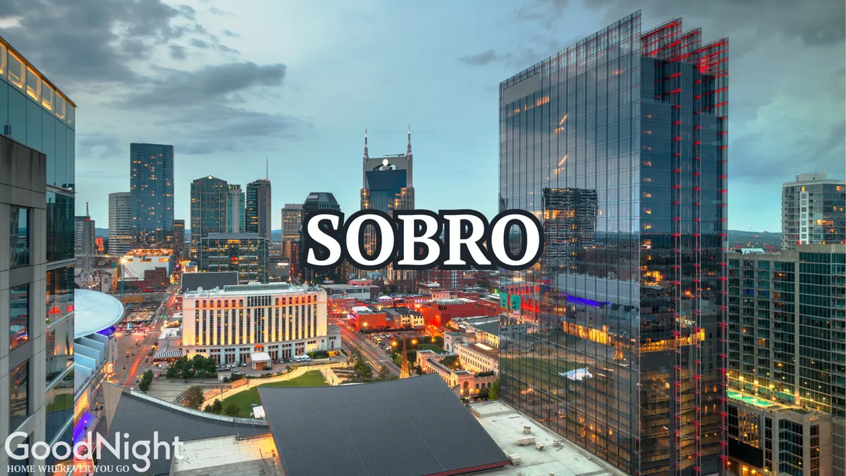 A vivid night-time cityscape with gleaming glass skyscrapers and neon lights illuminating the bustling urban core. The lively ambiance suggests endless options for nightlife, cultural events, and city exploration—perfect for after-work adventures or connecting with colleagues.